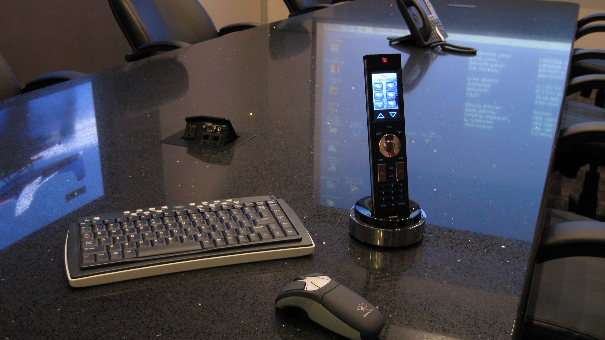 close up picture of smart remote on conference room table
