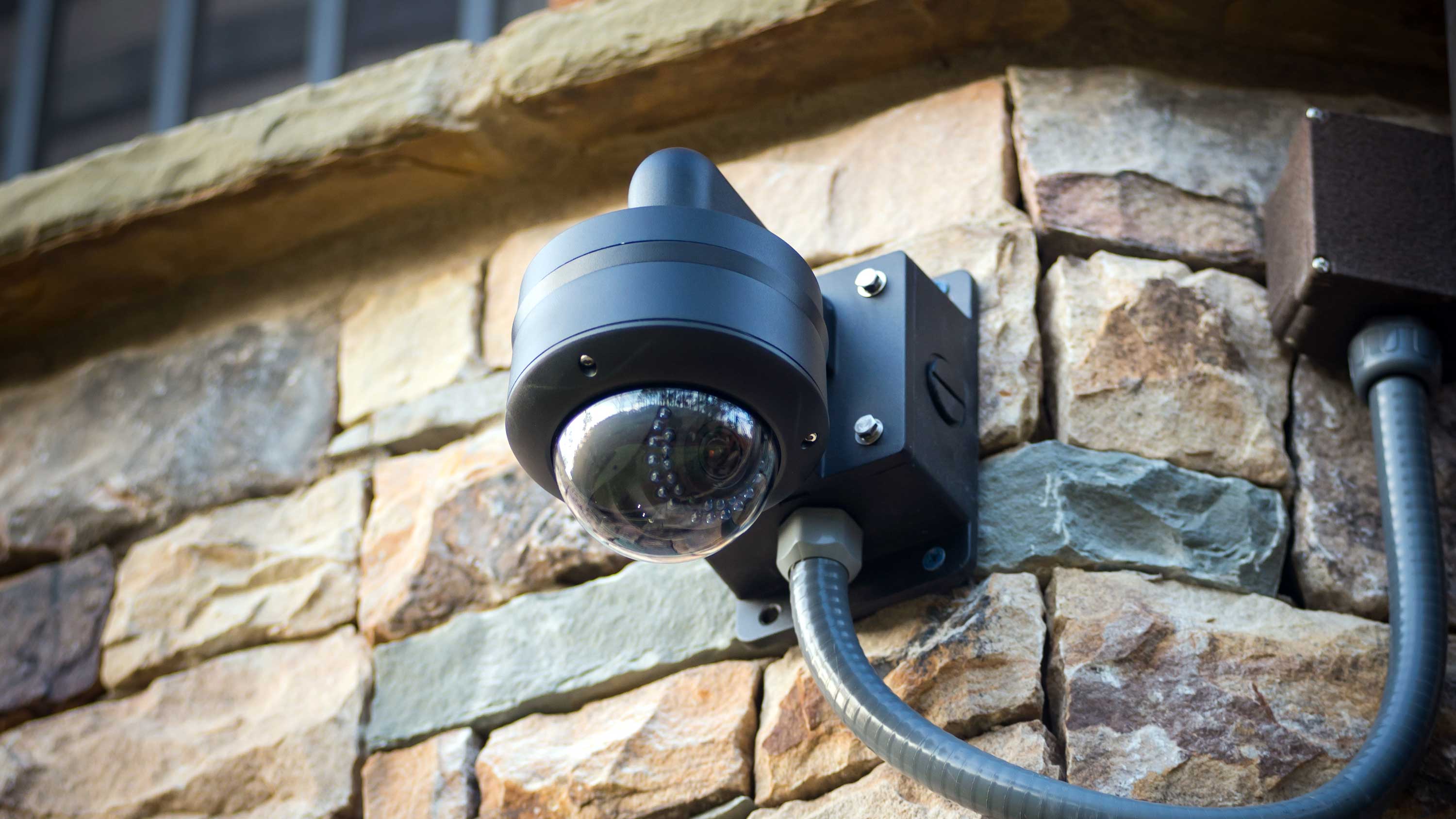 surveillance camer on stone wall