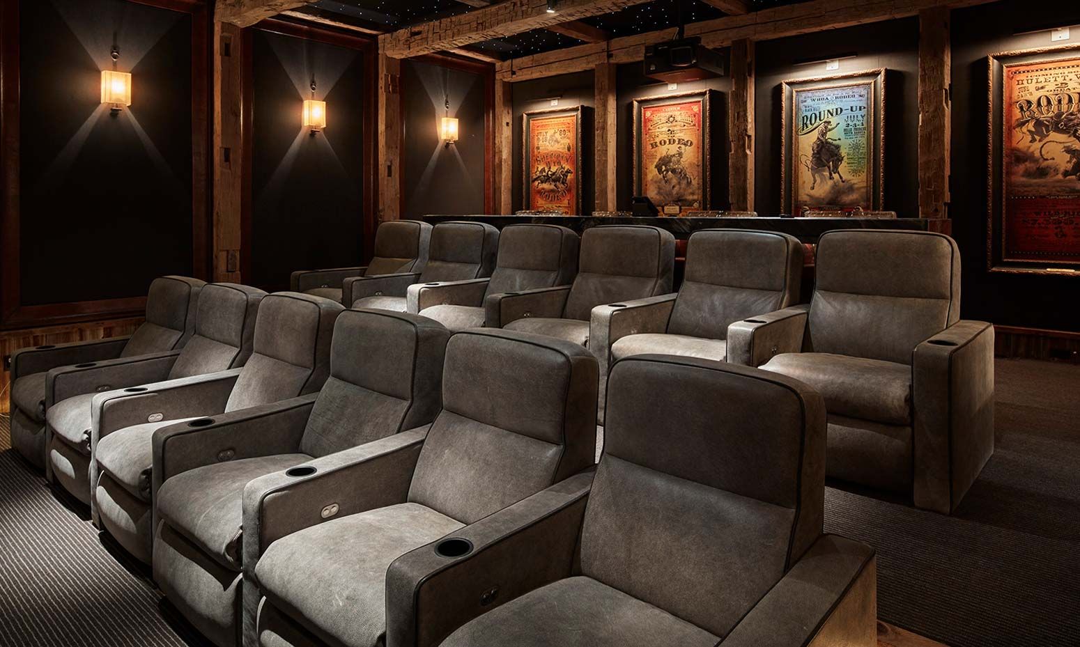 grey seats in a home theater with movie posters in background