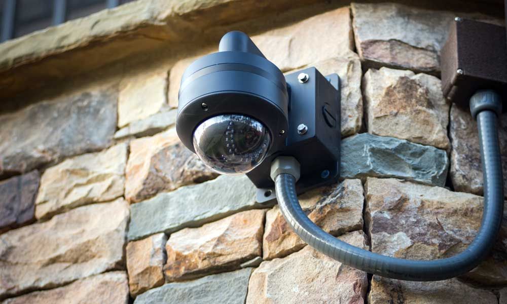 home security camera on stone wall