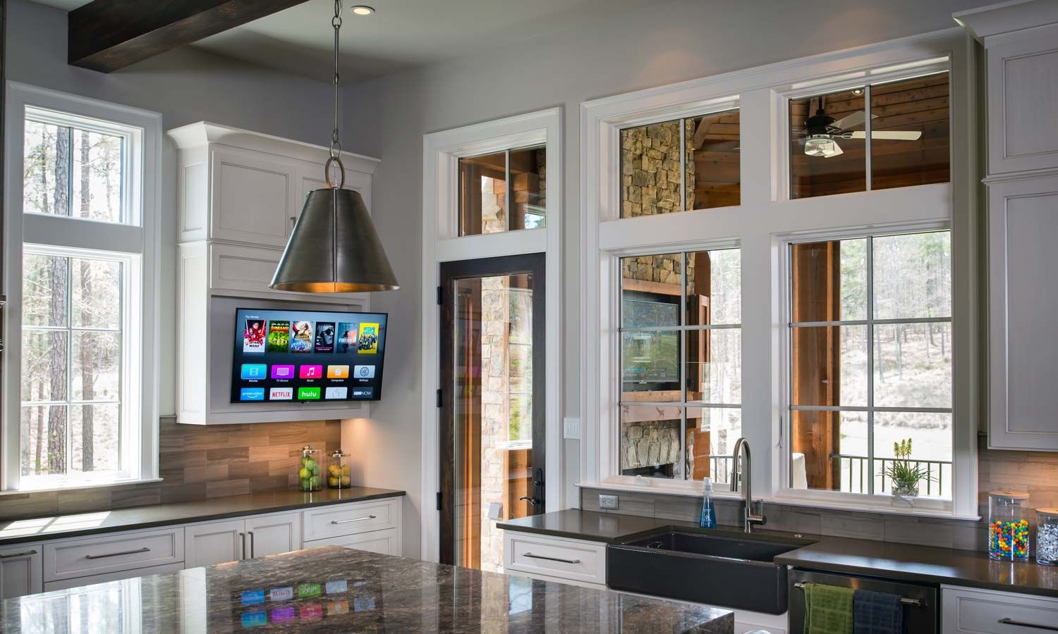 kitchen with large windows and tv on cabinets