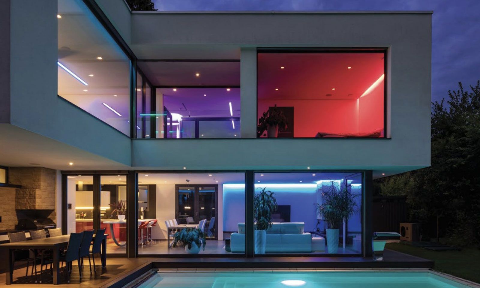 smart home with different colors of LED lighting in each window